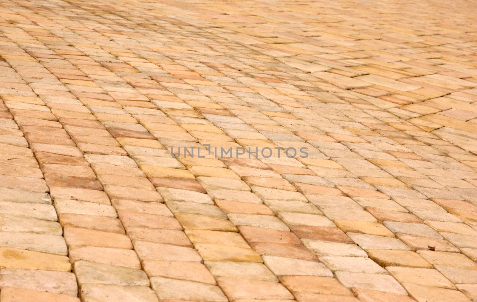 close-up of new old-style pavement of stoneblocks (bricks) of warm color