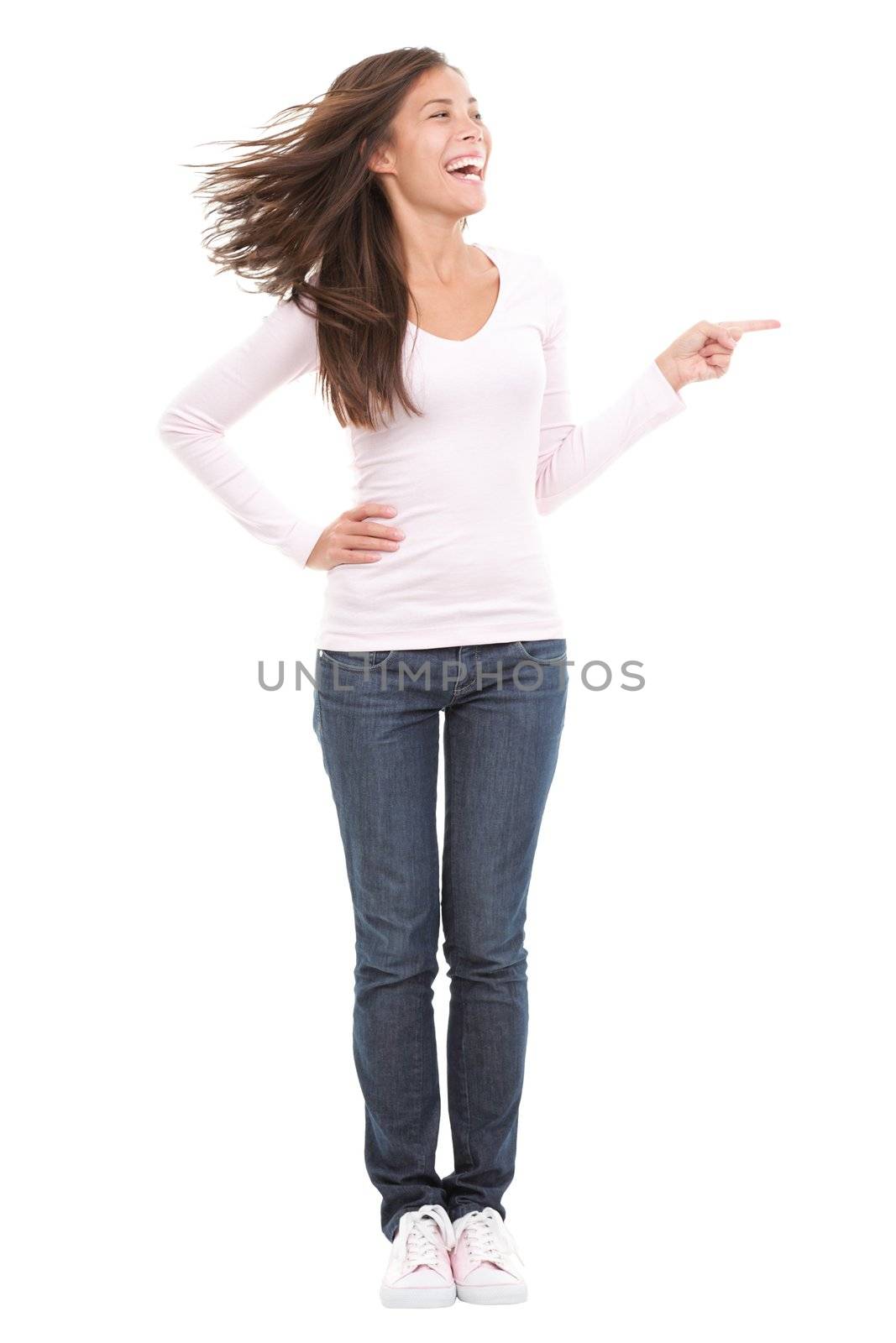 Funny and excited woman laughing and pointing. Beautiful mixed race asian / caucasian model in full length. Isolated on white background.