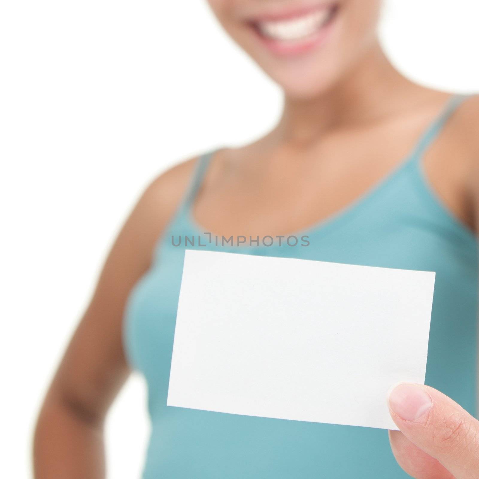 Young casual professional showing blank white business card / paper sign. Isolated on white background. Shallow depth of field, focus on card.