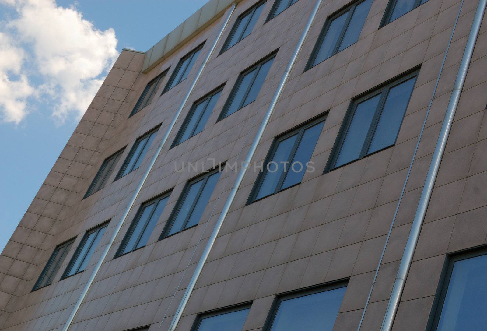 view of new modern office building and sky with clouds