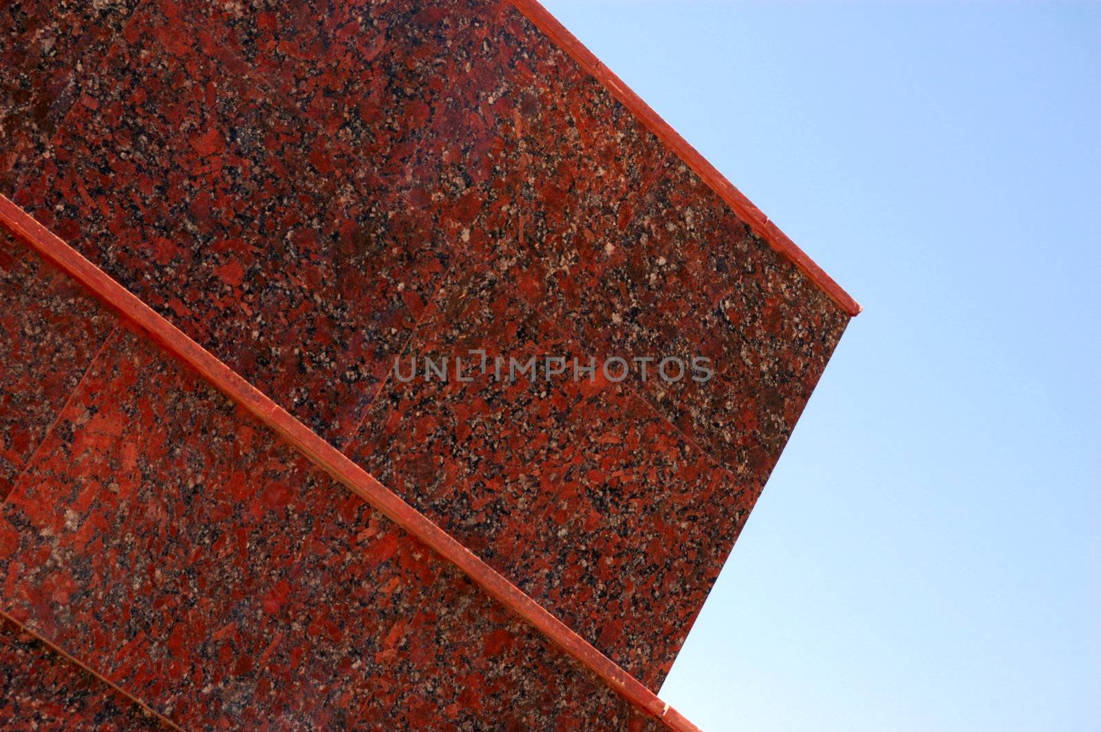 decoration of new modern office building (red granite thin slabs) against sky