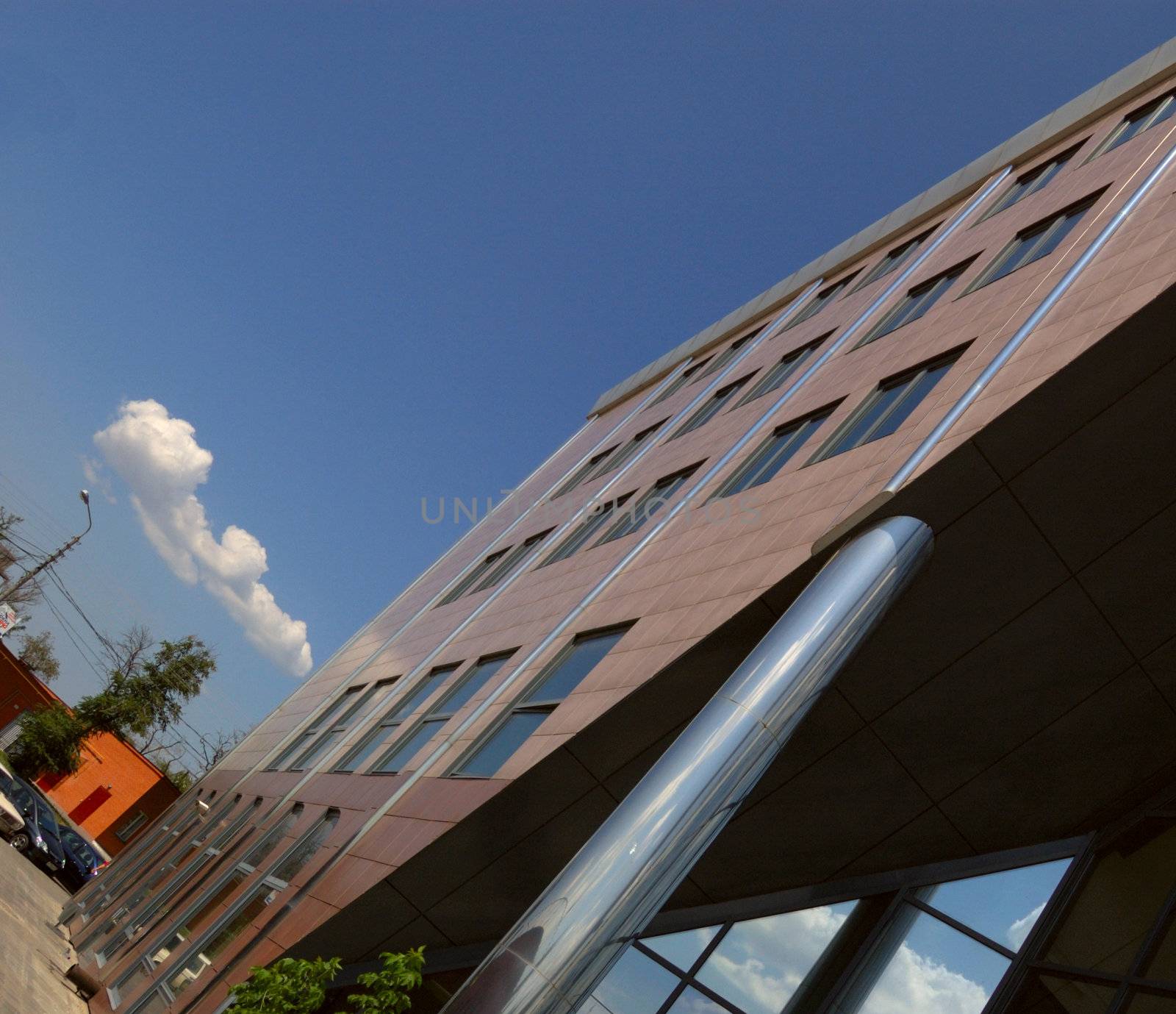 view of new modern office building and sky with clouds