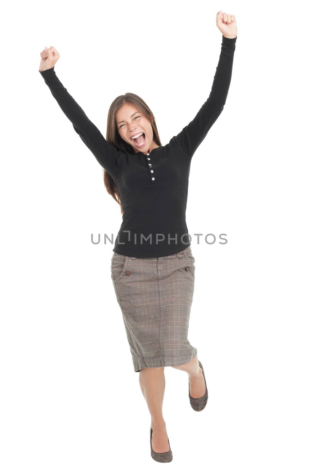 Winner woman. Casual young successful businesswoman jumping very excited. Isolated in full length on white background.