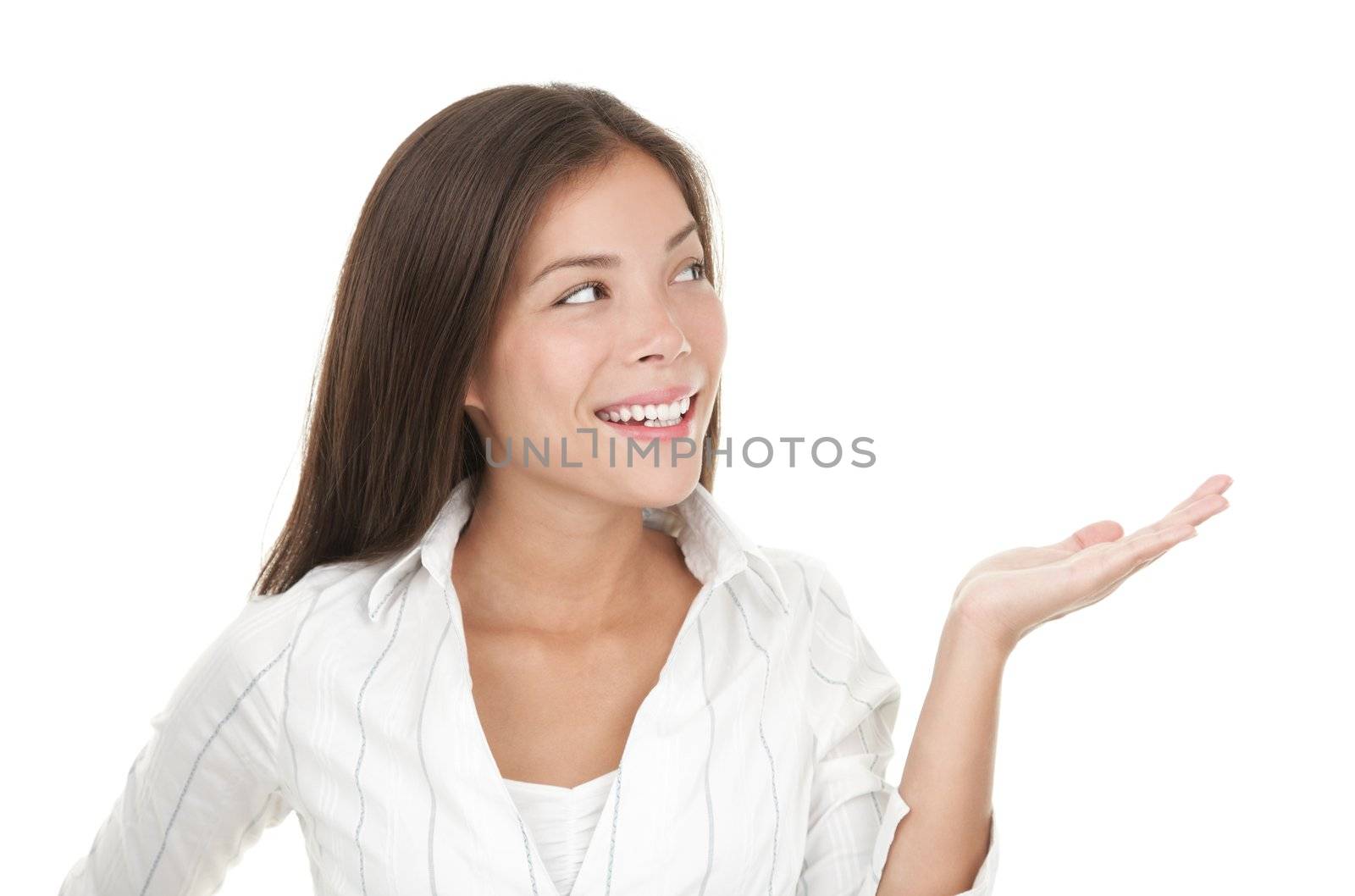 Woman presenting your product in her open hand / palm.  Casual beautiful young mixed race chinese / caucasian businesswoman isolated on seamless white background
