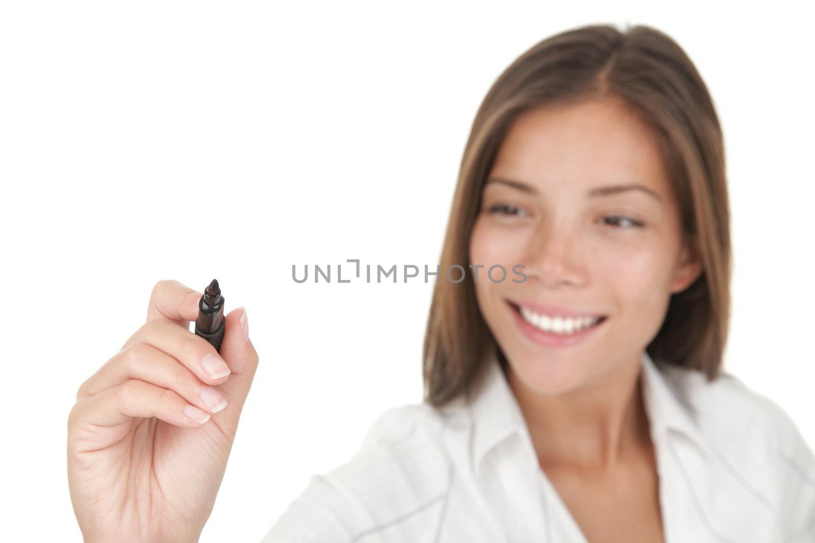 Writing with pen. Young beautiful businesswoman with pen writing on the screen. Focus on the black marker - lot's of copy space. Mixed race chinese / caucasian model isolated on seamless white background. 