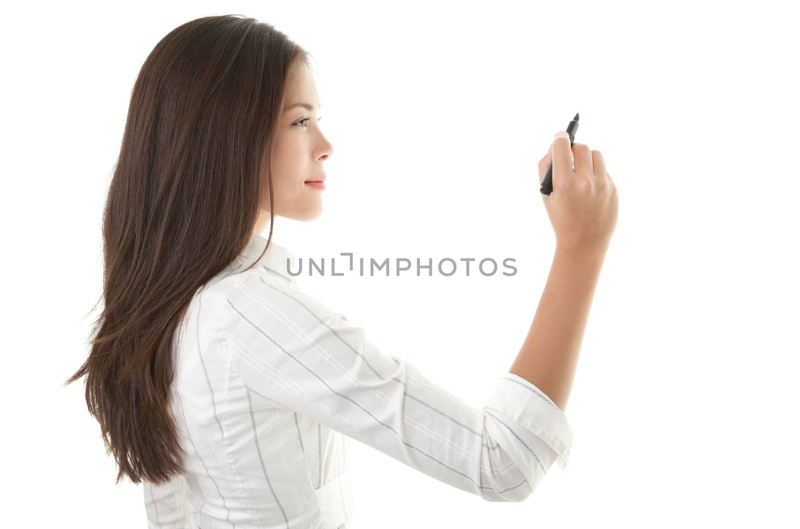 Businesswoman writing or drawing with pen on copy space / whiteboard. Casual beautiful young mixed race chinese / caucasian business woman isolated on seamless white background. Bright with backlight