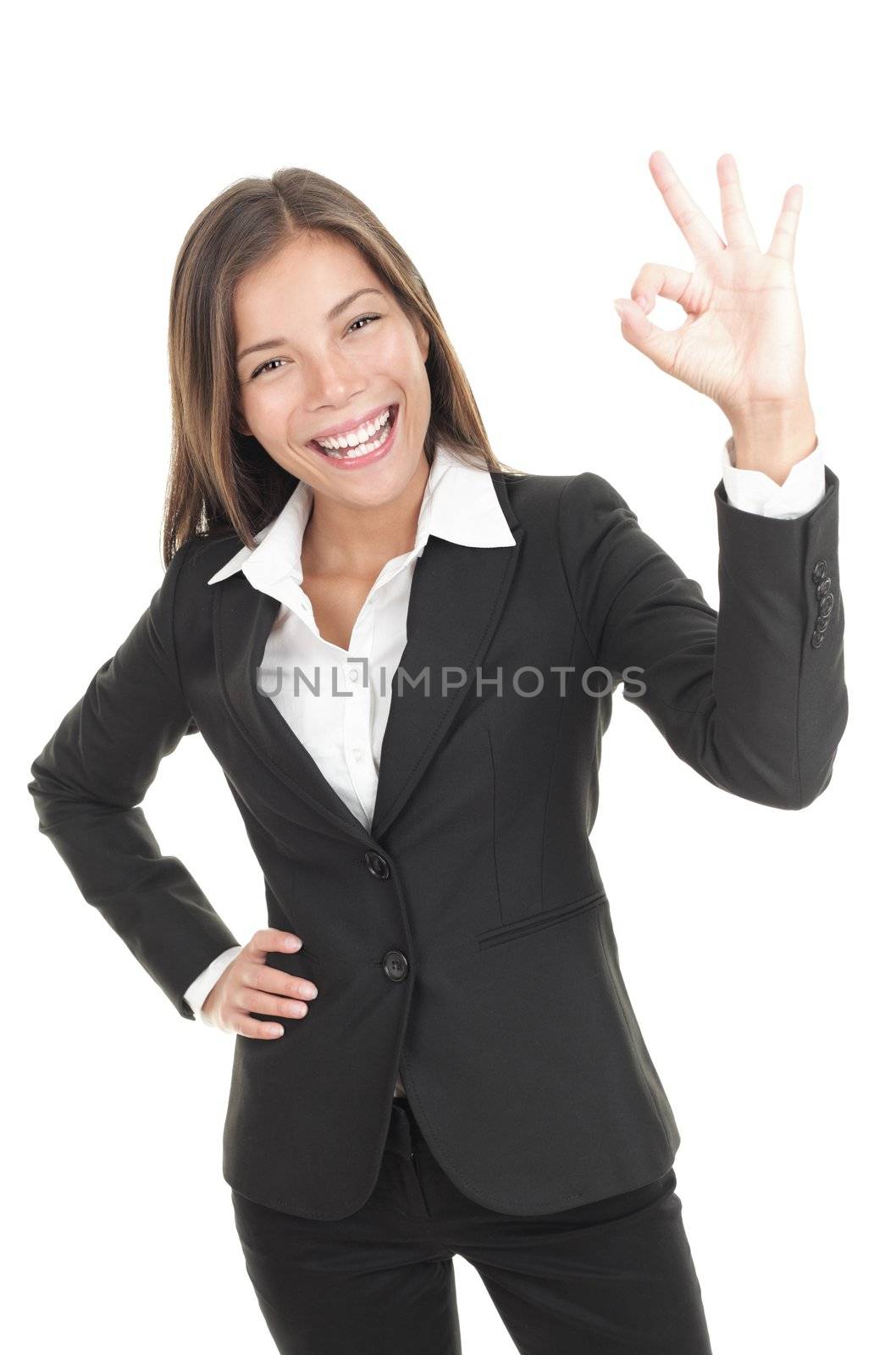 OK sign woman. Businesswoman showing okay hand sign. Successful and beautiful mixed race chinese / caucasian business woman isolated on white background. 