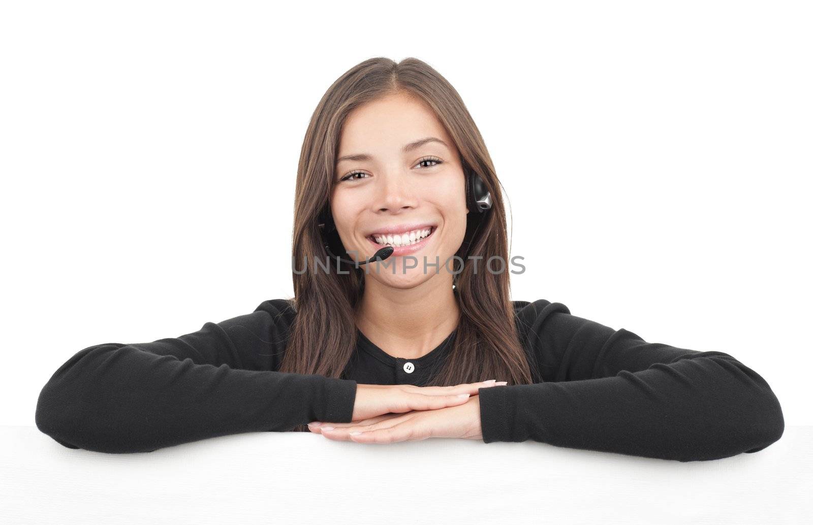 Headset woman from call center leaning over billboard. Isolated on white background. 
