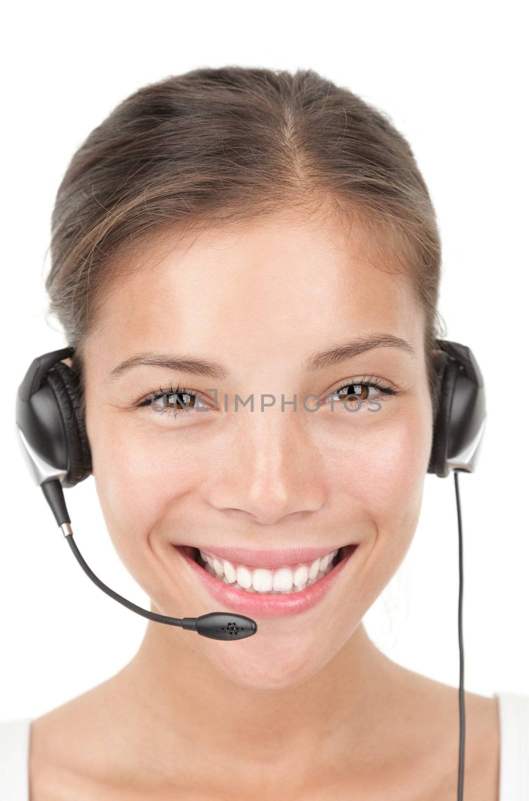 Headset woman portrait.. Closeup of beautiful young mixed race chinese / caucasian secretary / assistant speaking with headphones while working in call center. Isolated on white background.