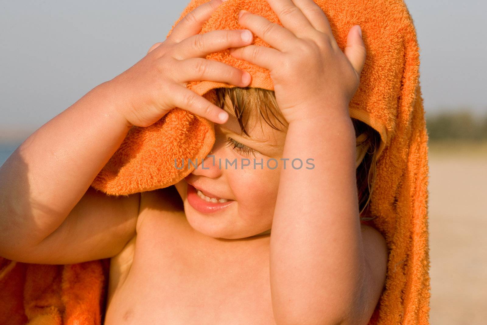 people series: portrait of little girl in orange towel