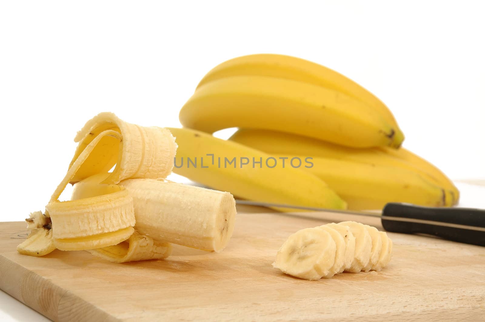 bananas on carving board on white background