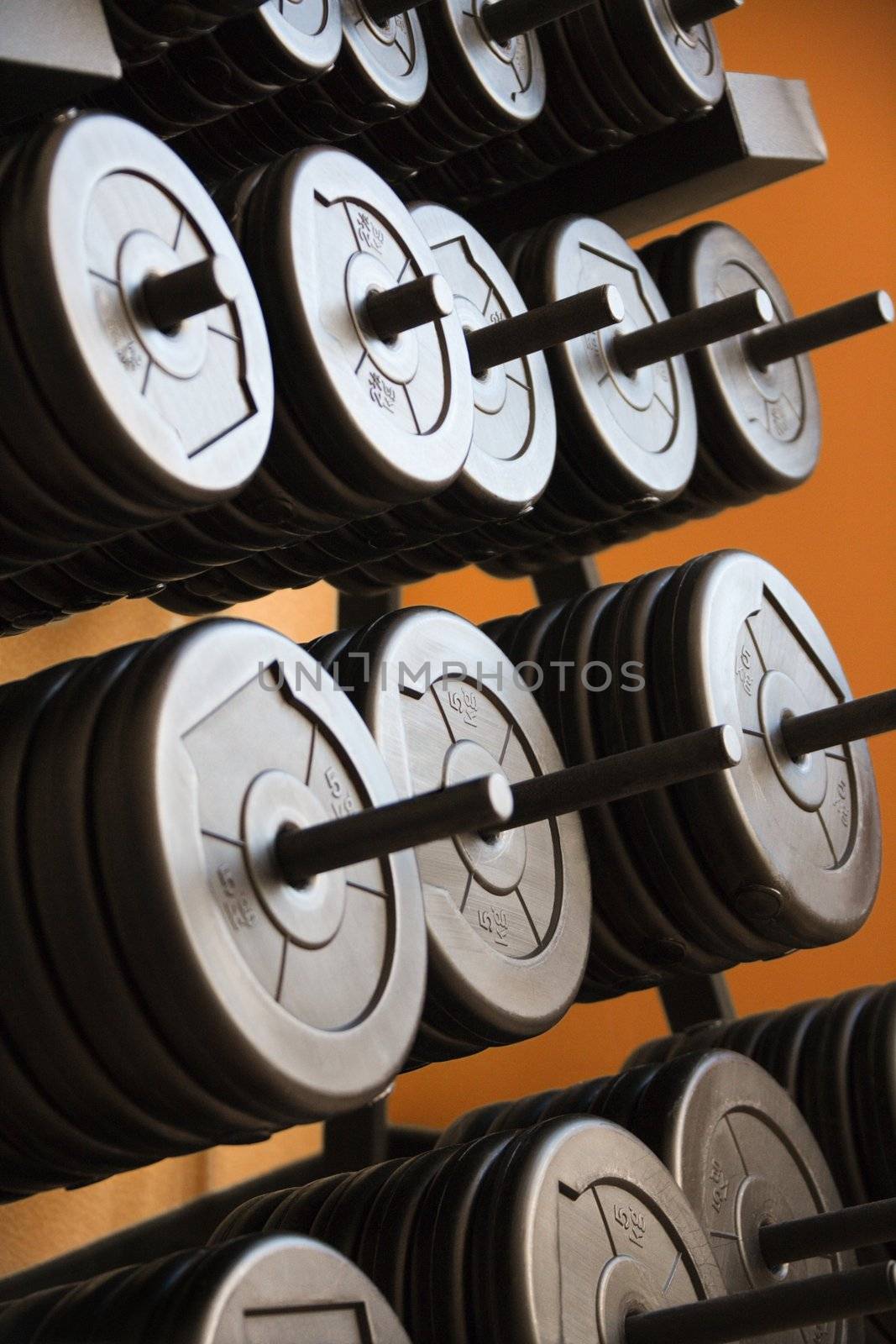 Stacked barbells with weights.