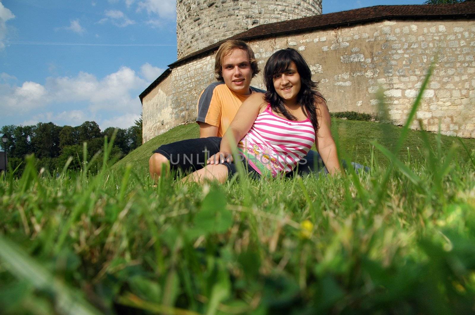couple in green landscape with castle