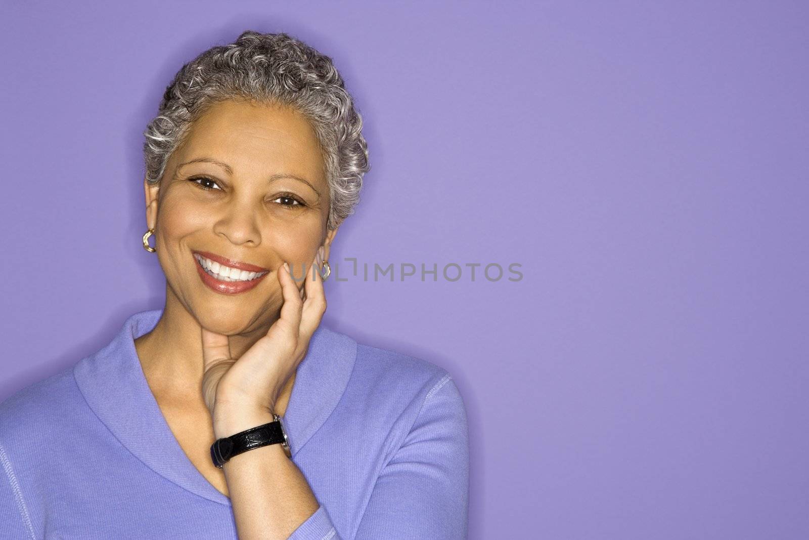 African American mature adult female smiling looking at viewer.