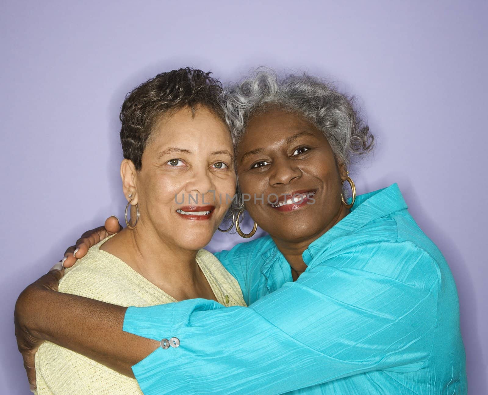 Mature adult African American female looking at viewer smiling.