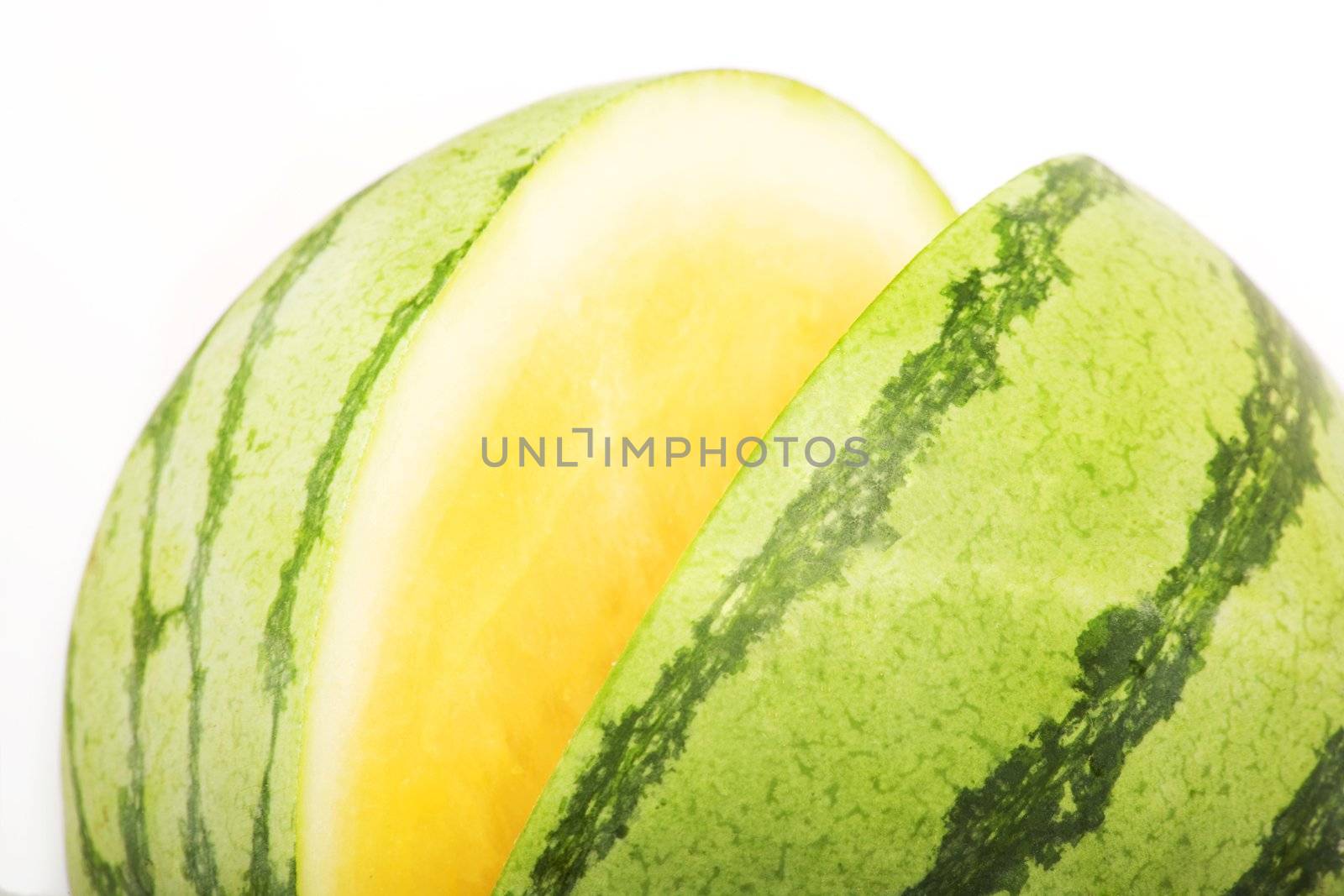 Bright yellow and green watermelon on a white background
