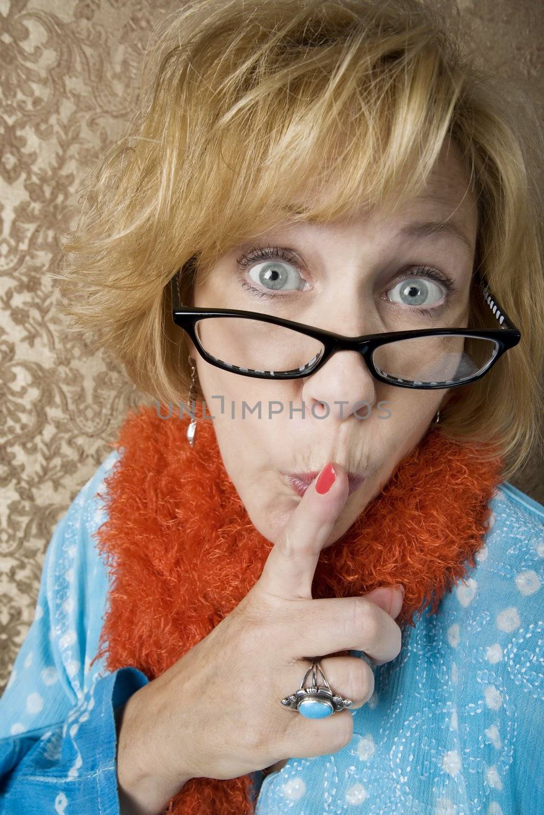 Crazy woman with glasses putting her finger to her lips