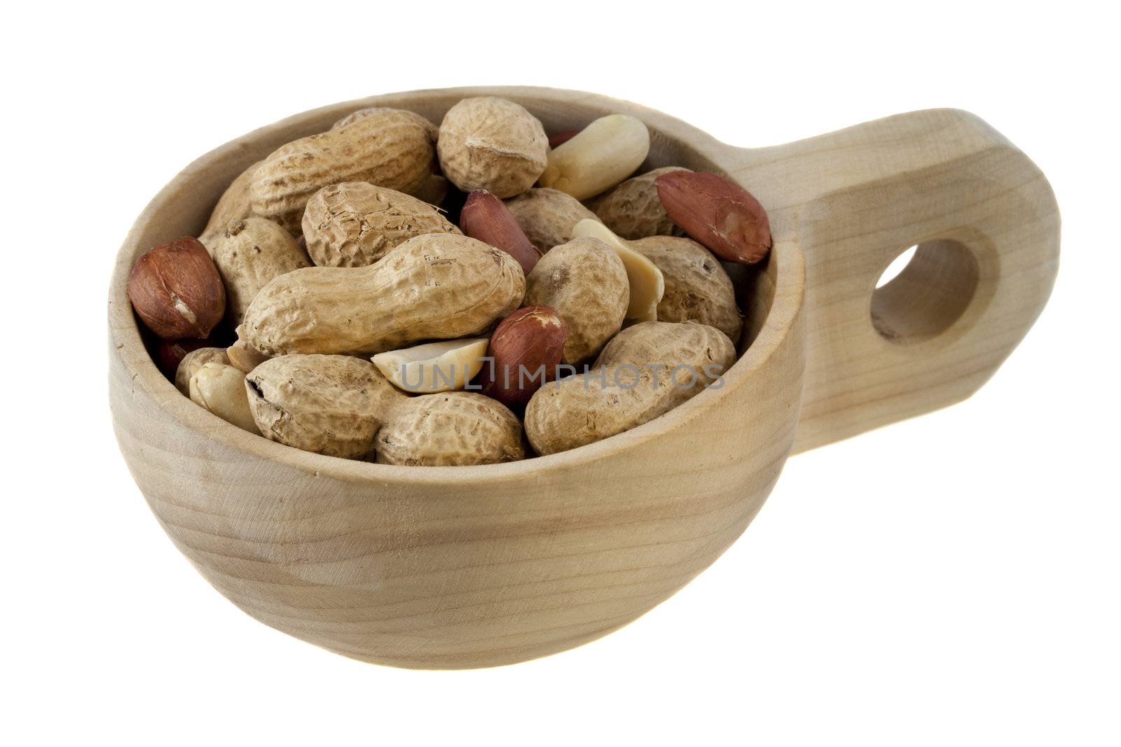 peanuts shelled and  in shells on a small, rustic, wooden scoop or cup, isolated on white