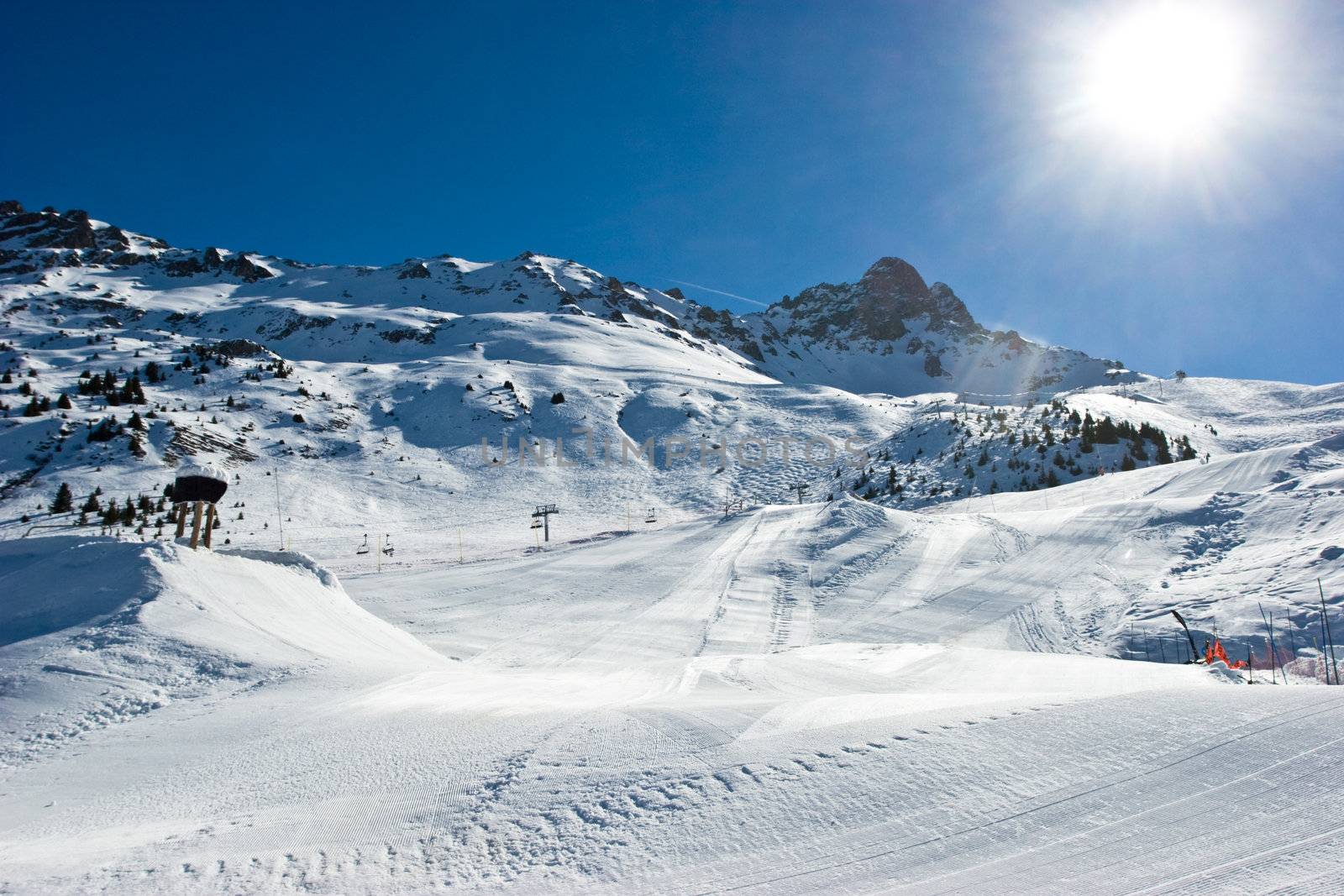 Fresh ski slope with snowcat tracks in Meribel Valley, French Alps