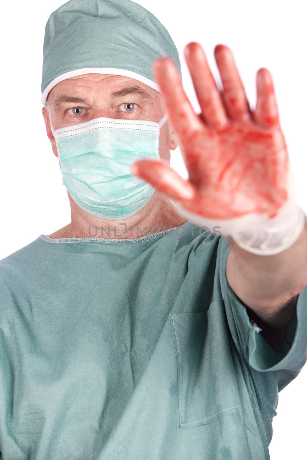 A 60 year old surgeon with bloody hands on a white background.