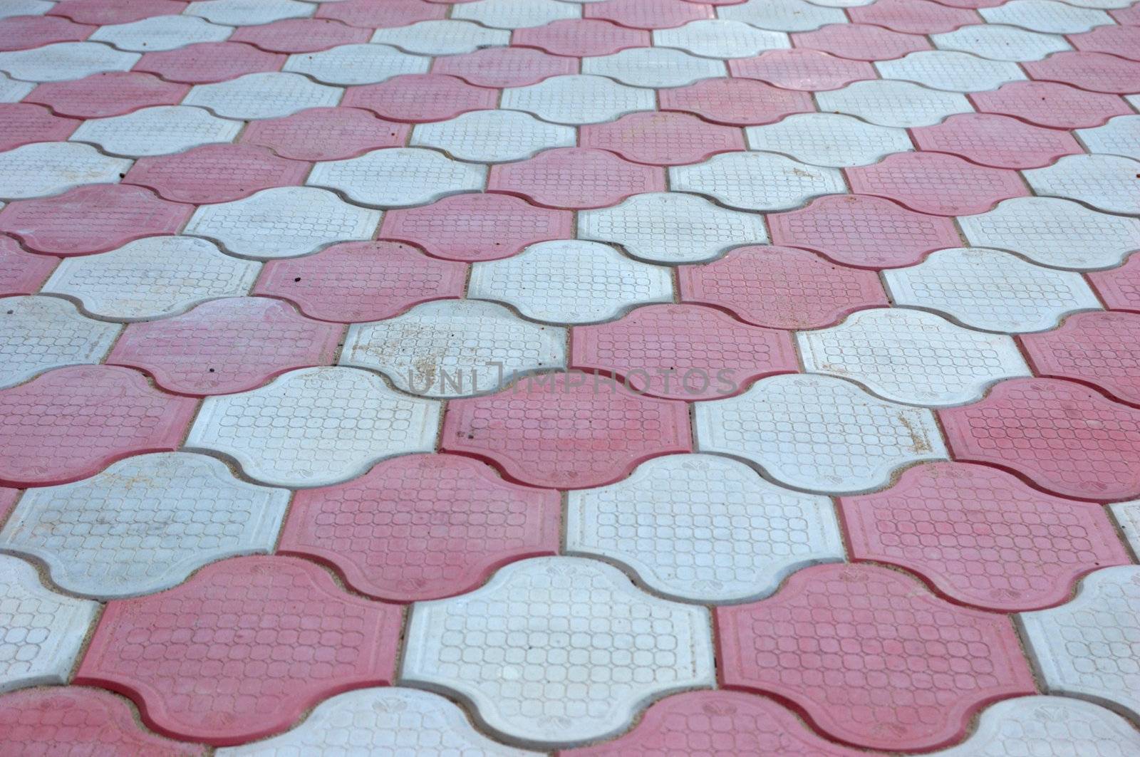 close-up of new old-style pavement of figured stoneblocks (bricks) of red and light color