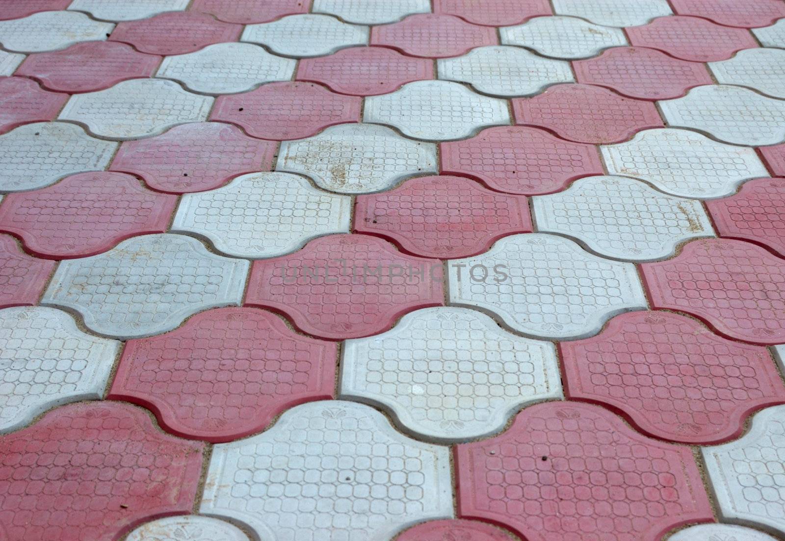 close-up of new old-style pavement of figured stoneblocks (bricks) of red and light color