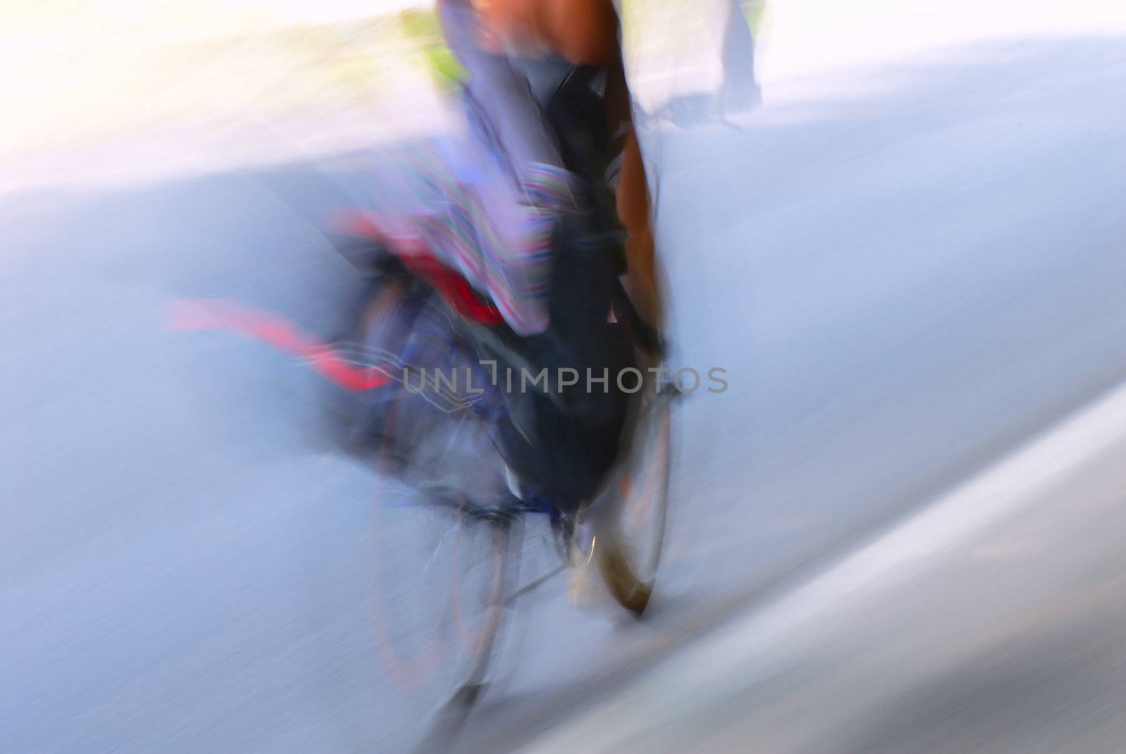 The out-of-focus image of the bicyclist on road.