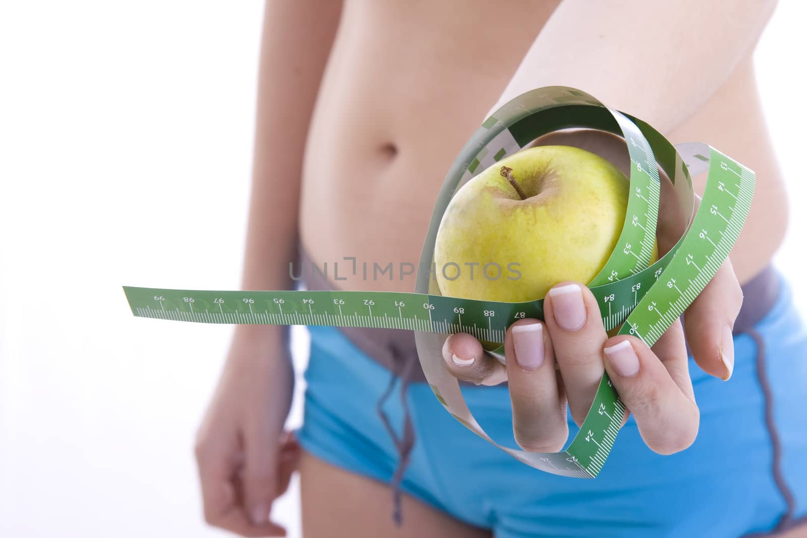 green apple and measuring tape isolated on a white
