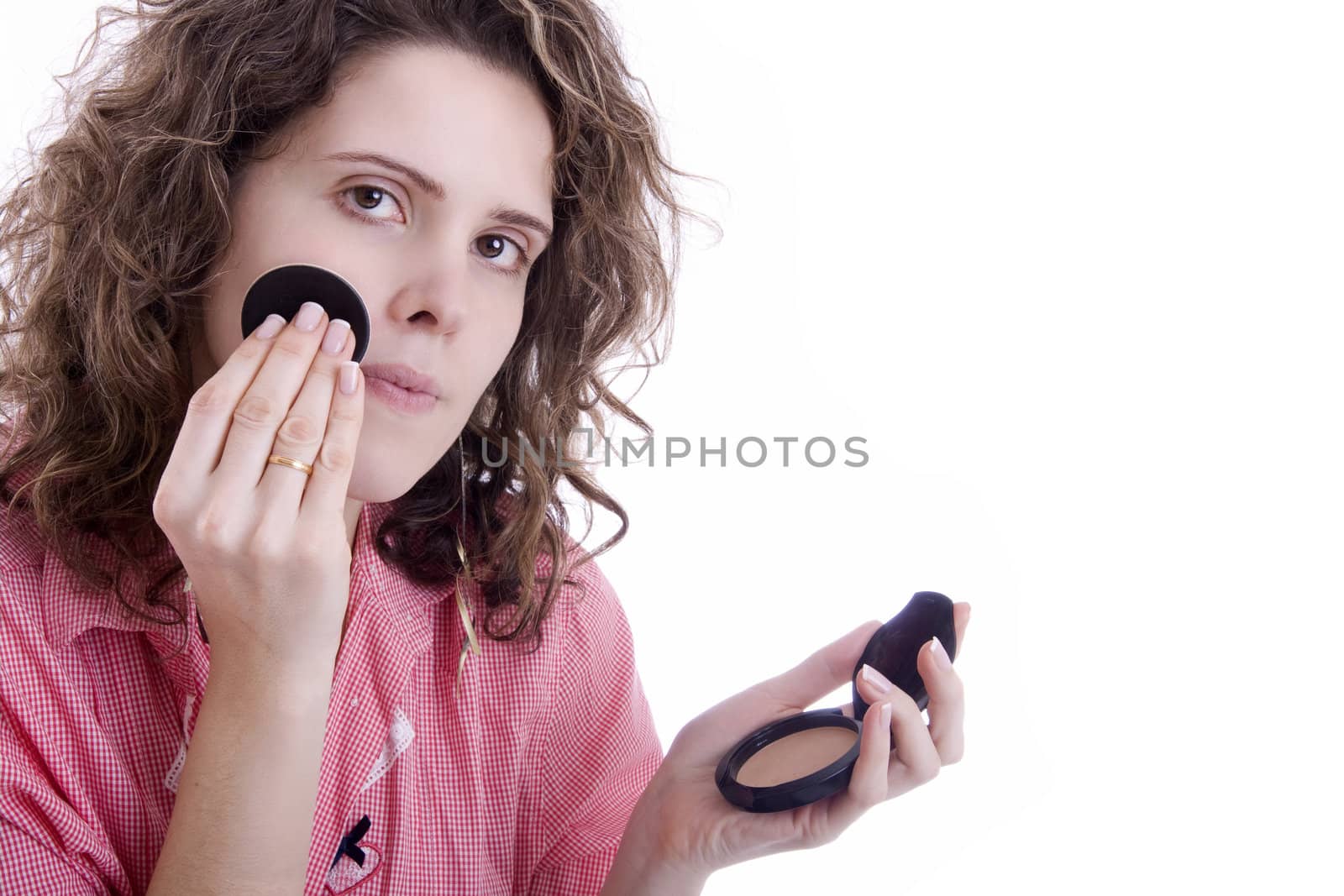 Woman ruddies her face on white background
