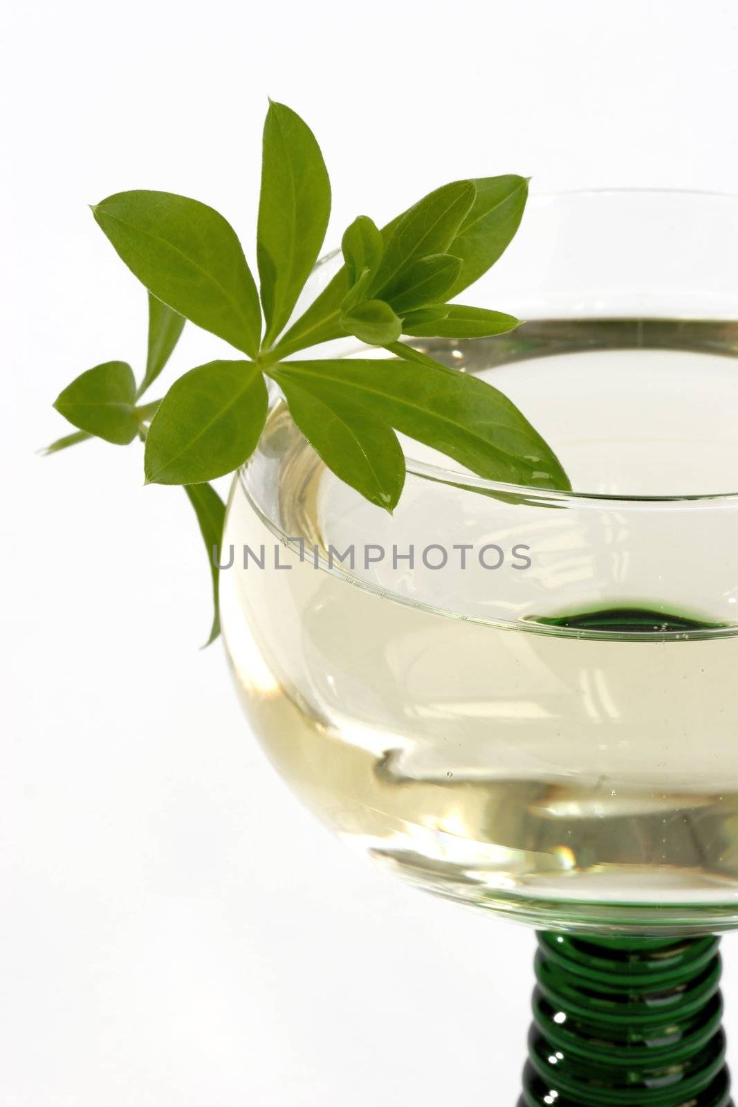 Close up of woodruff wine in a glass on bright background