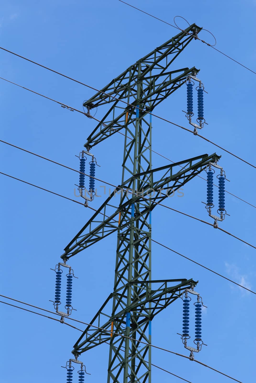 Support of an electricity transmission on a background of the clear blue sky.