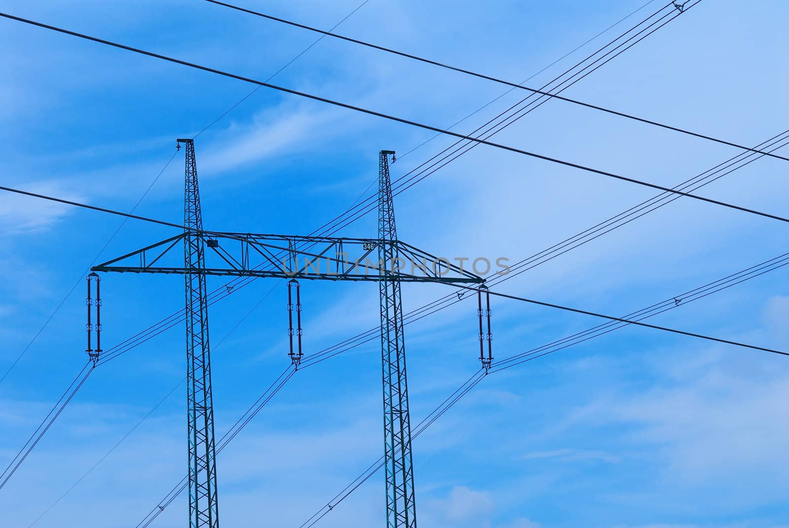 Support of an electricity transmission on a background of the clear blue sky.