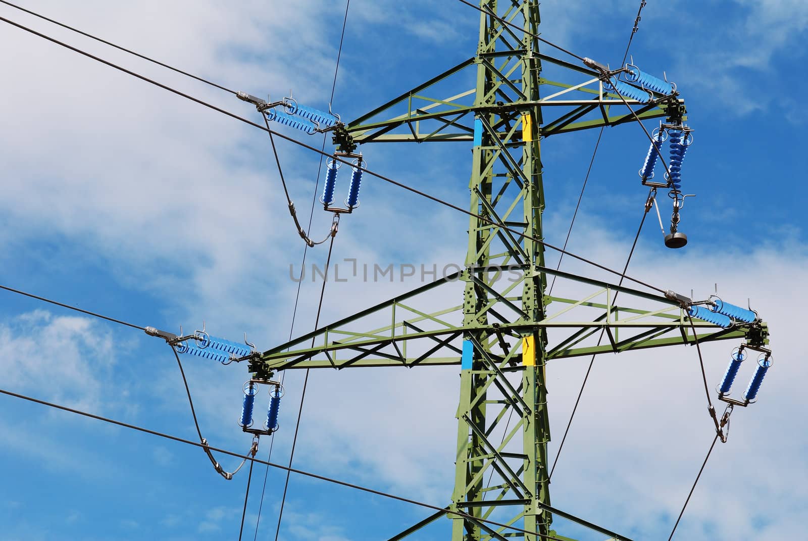 Support of an electricity transmission on a background of the clear blue sky.