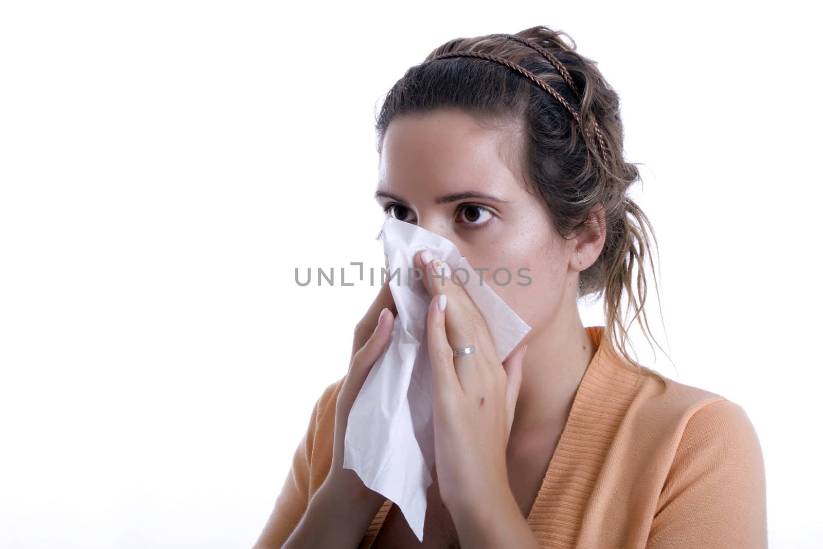 Woman cleaning her nose with a tissue
