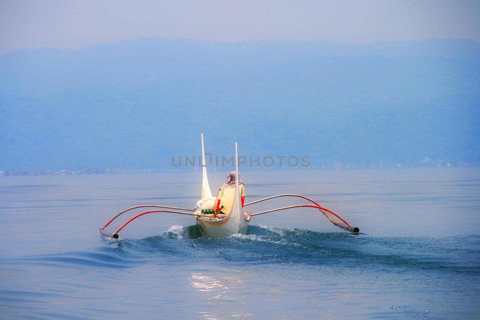 fishermans boat sailing at the mystic blue sea
