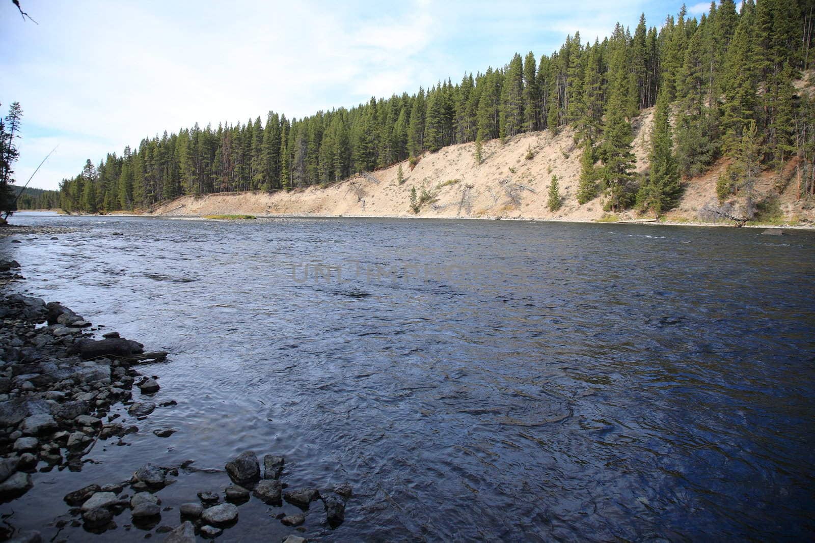 Rocky shoreline of river cutting through Wyoming National Park