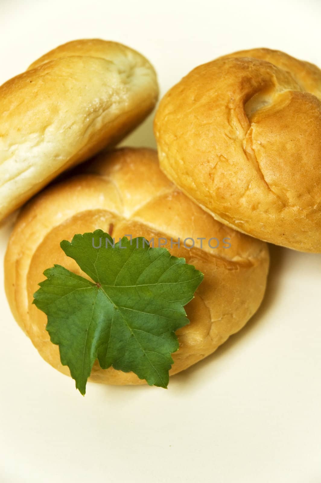 Three bread roll on kitchen table.