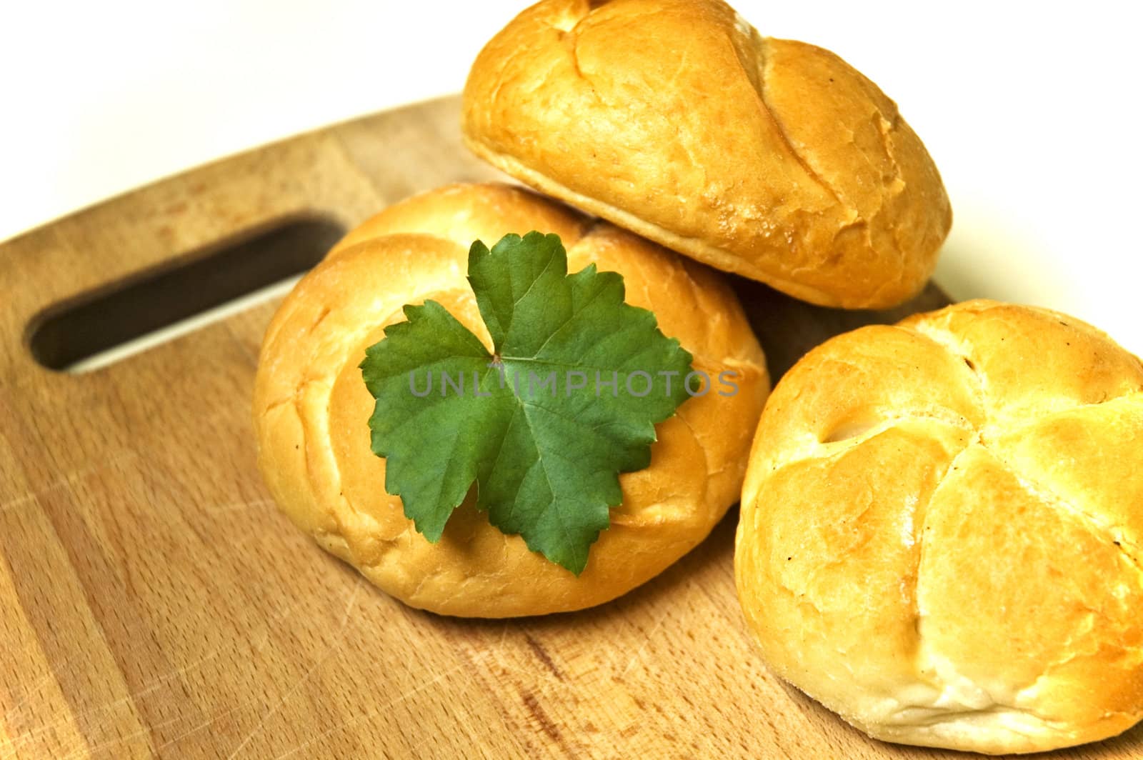 Three bread roll on board.