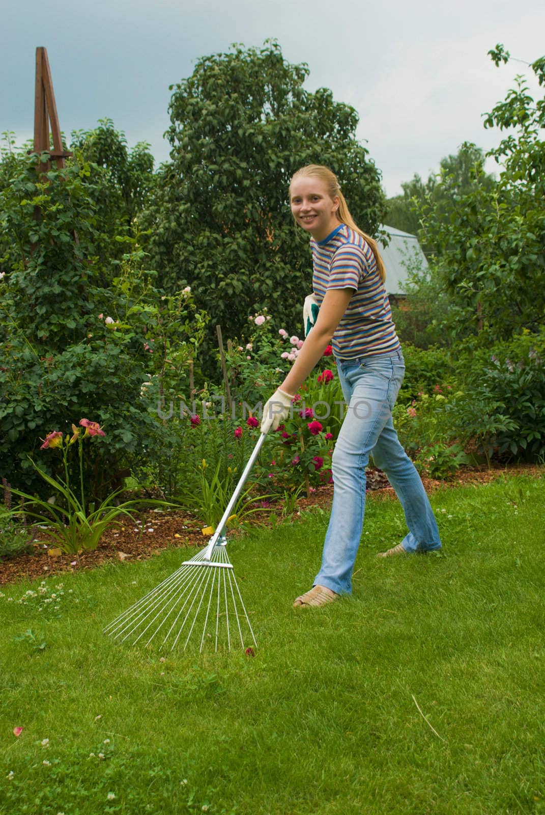 Happy young women cleaning the lawn