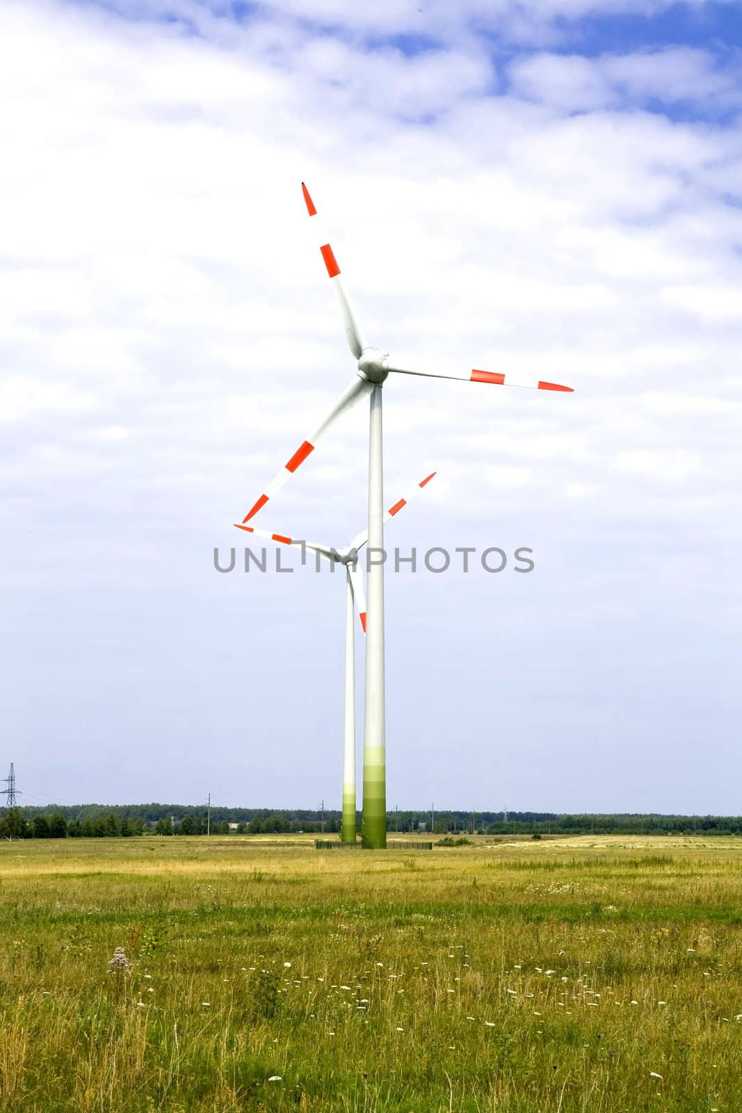 Energy concept - wind turbines in beautiful summer landscape