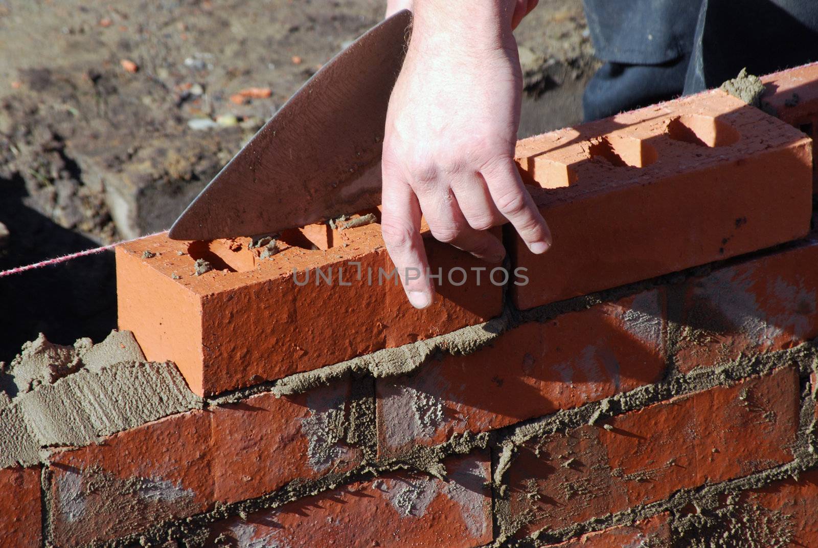 Close up of bricklayer at work 