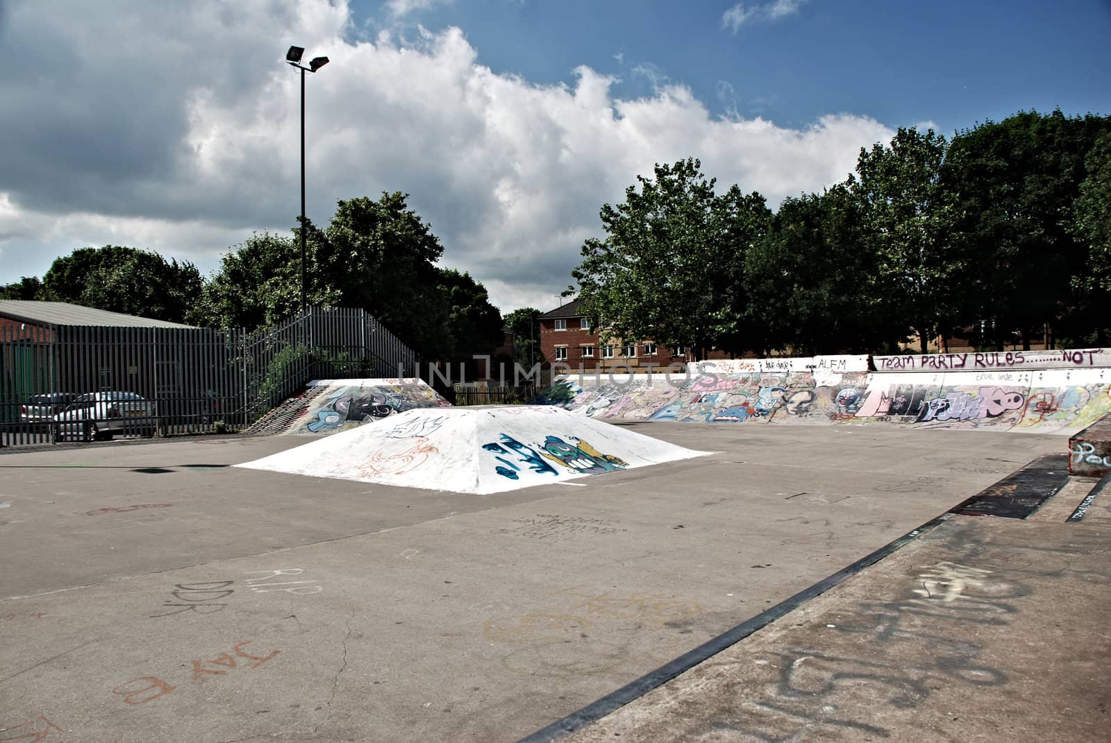 A photograph of a skate boarding park with ramps and graffiti