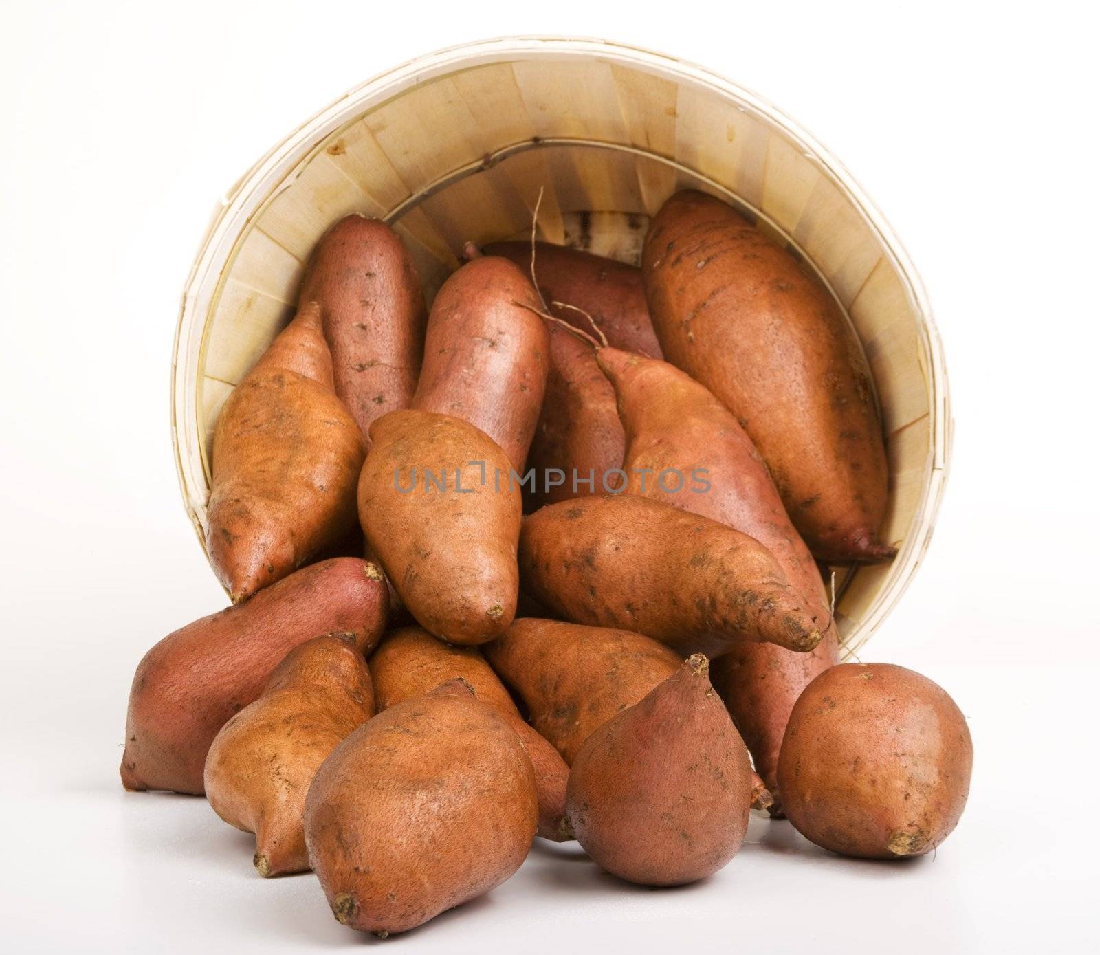 Red Sweet Potatoes pouring out of a Woven Basket