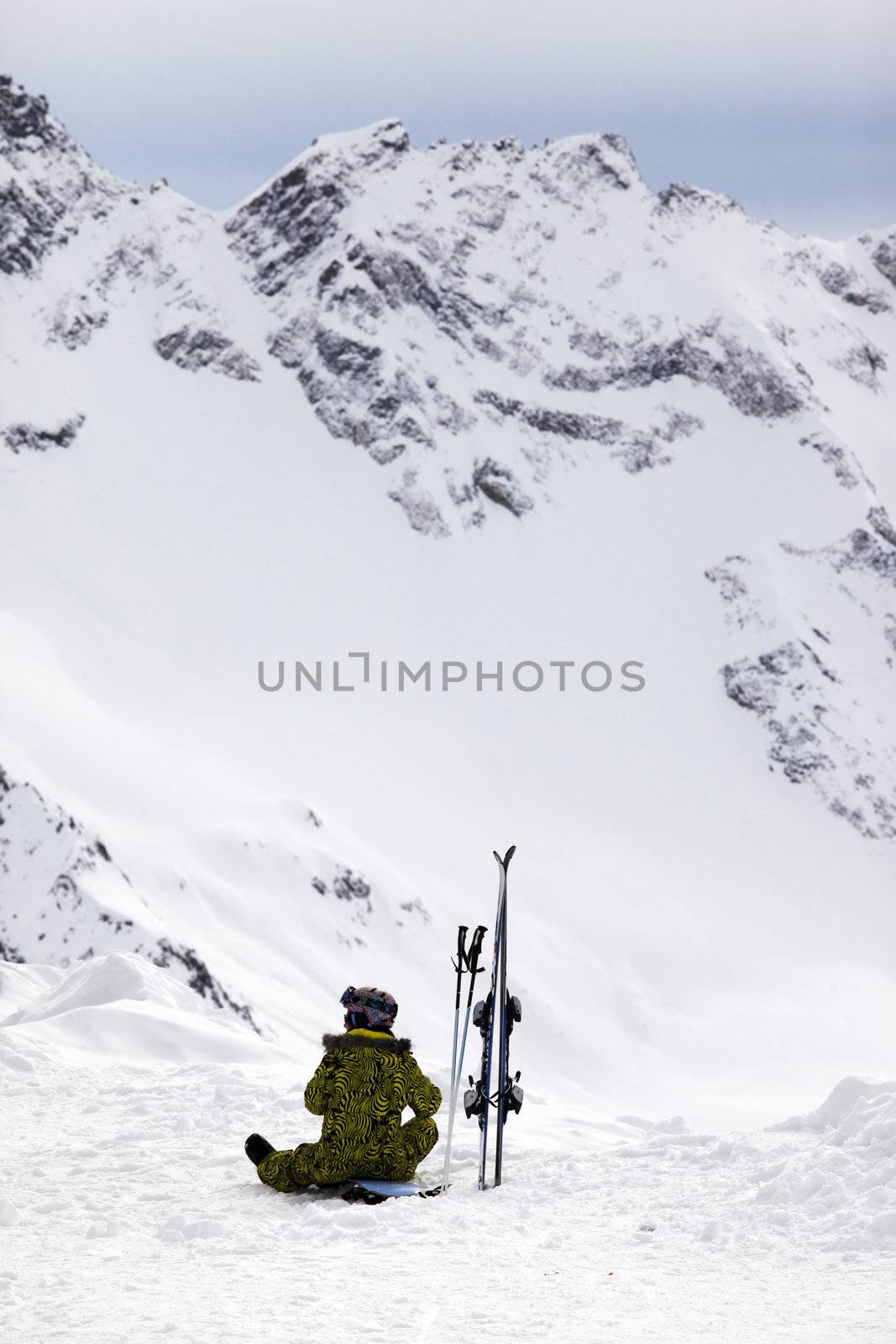 Skier girl on a background of high mountain