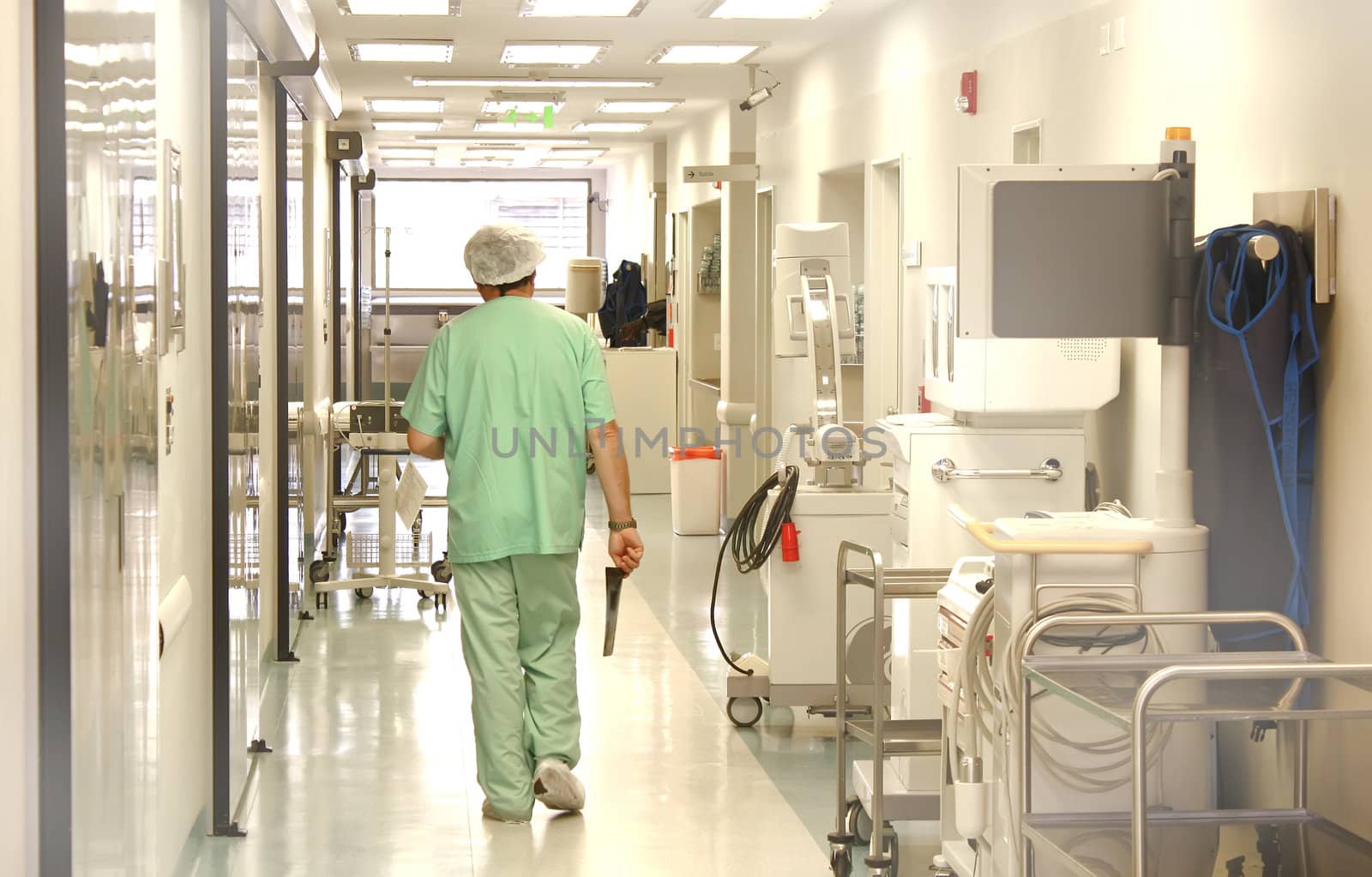 Doctor using srubs walking at the hospital corridor 