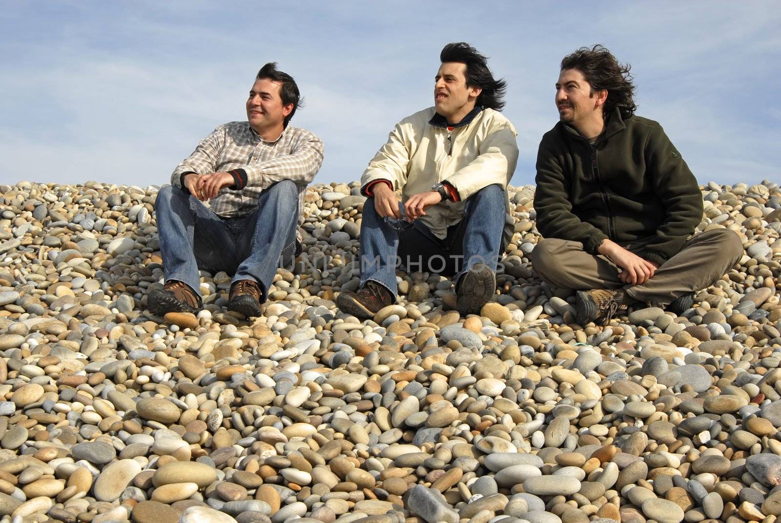 three casual young men at the beach