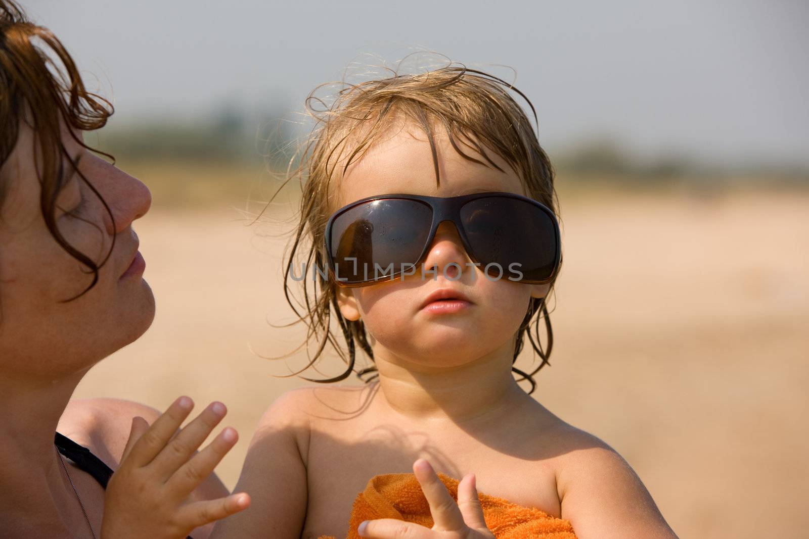 little girl are play with the sun glasses