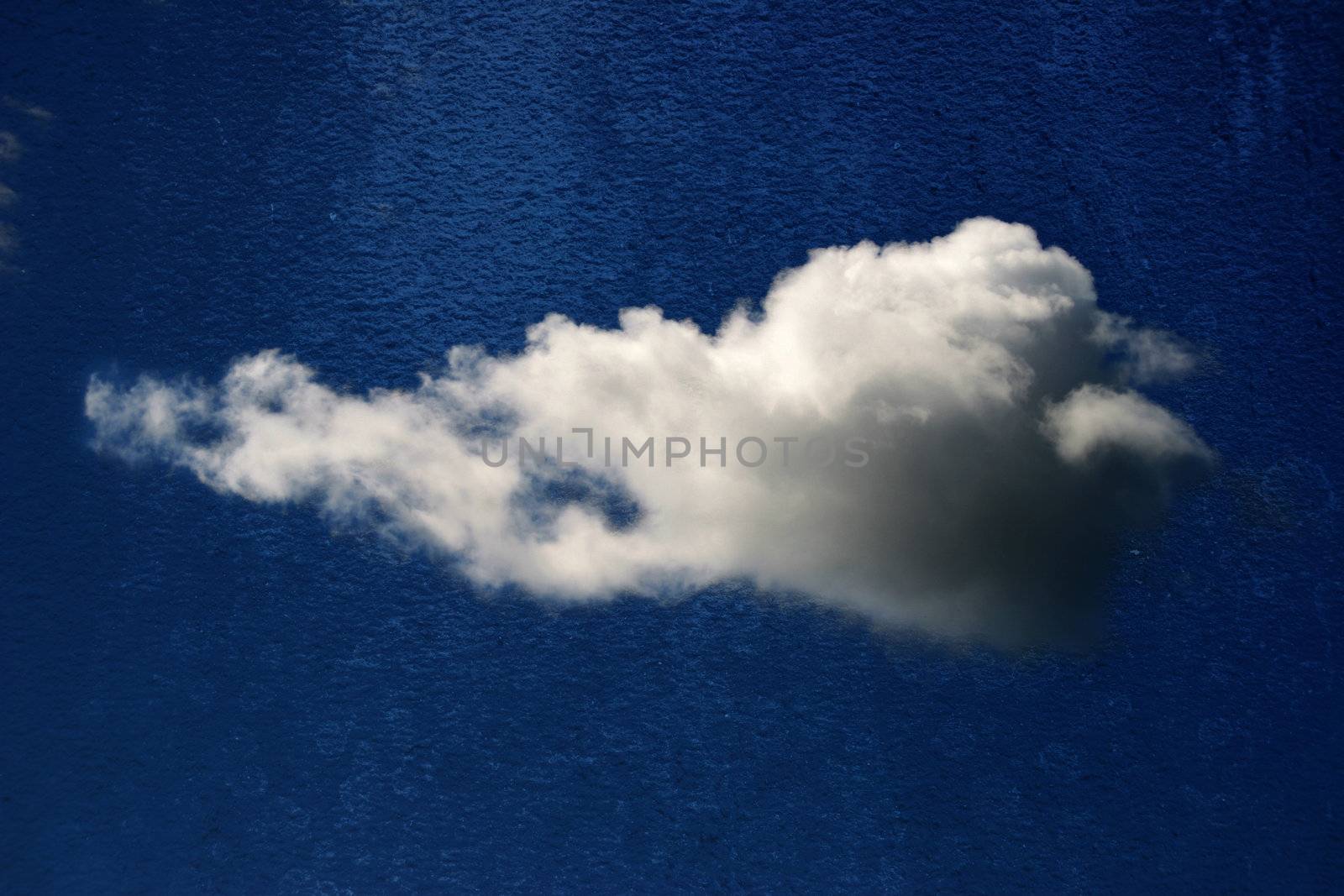 fluffy white cloud isolated on rought blue textured background