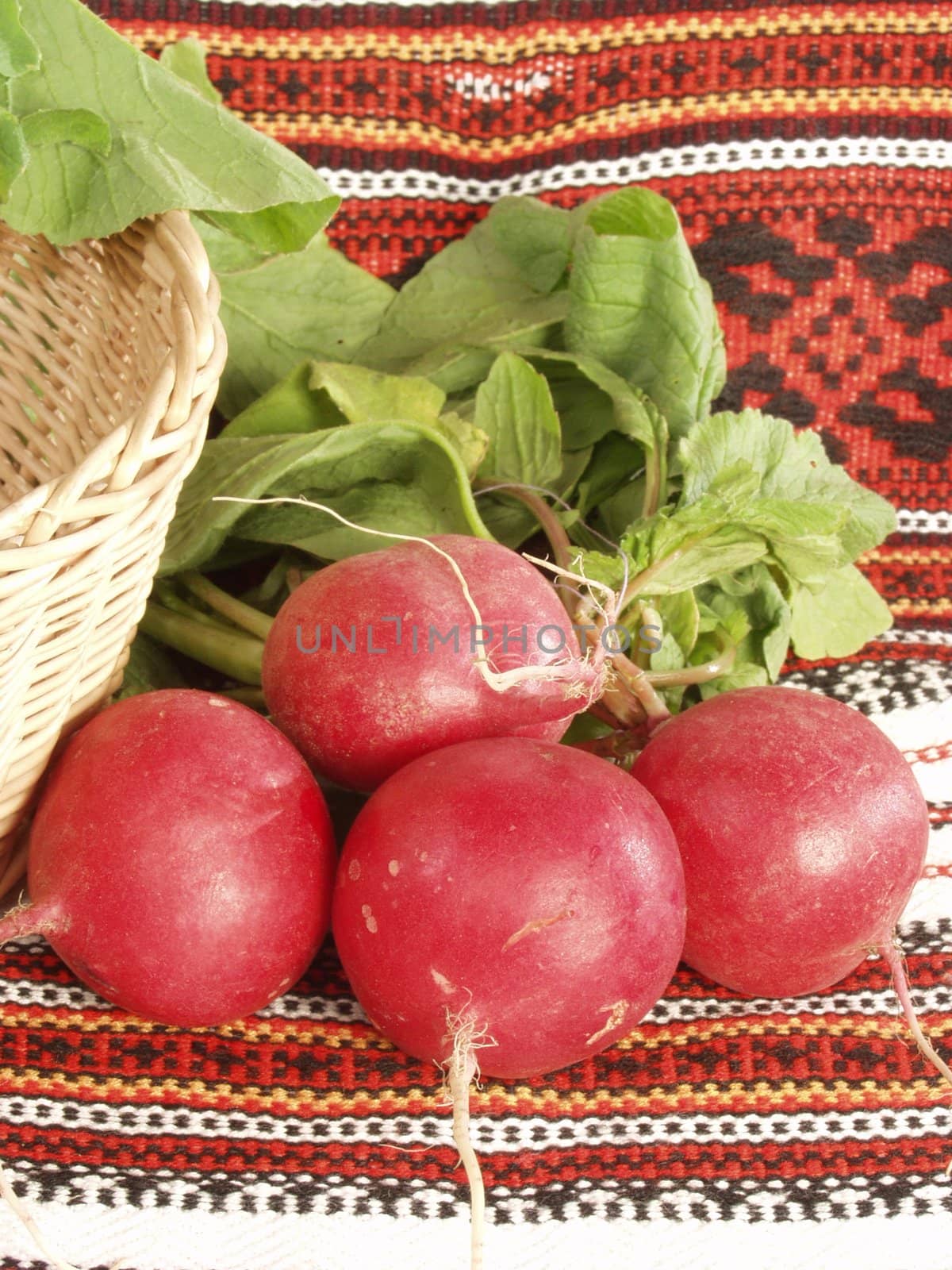 Garden radish and fragment of a basket with the Ukrainian national towels     