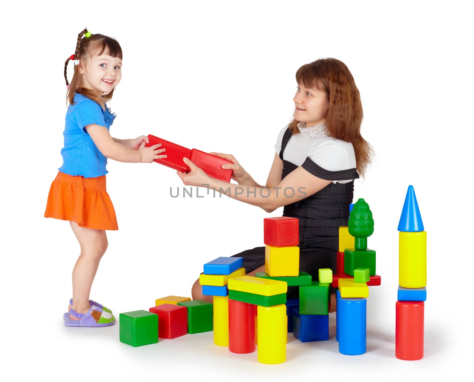 Little girl with mother playing with colored blocks on white background